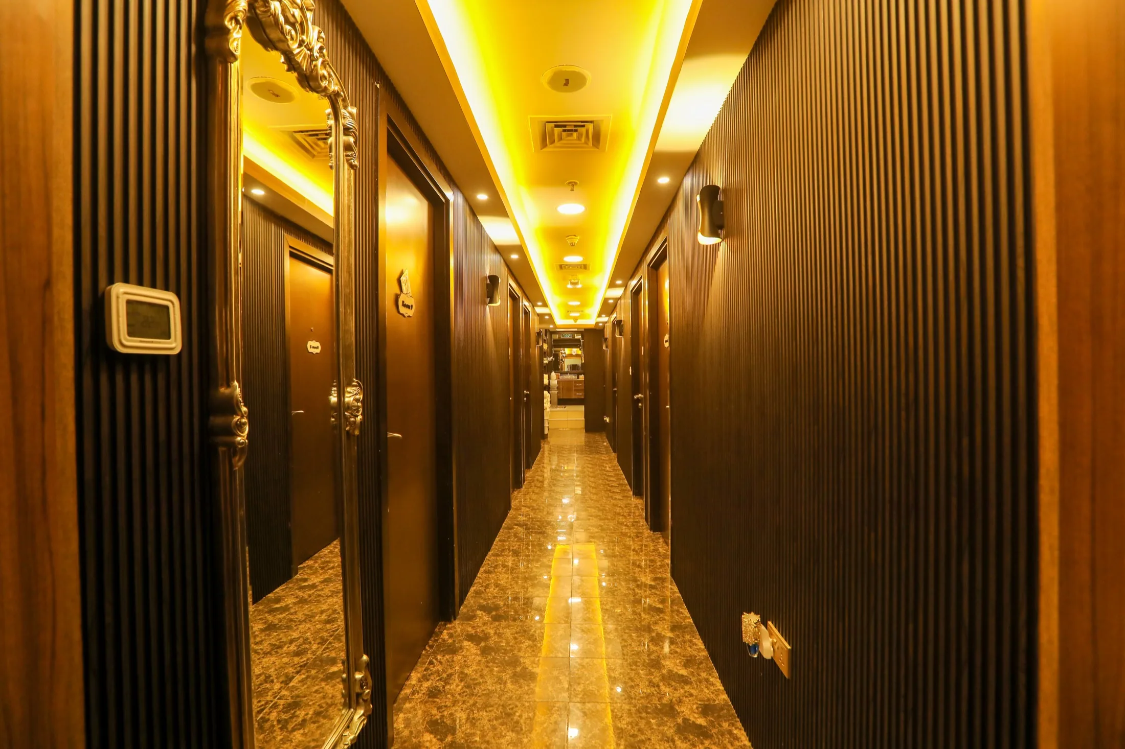 Gold hallway corridor inside Impressive Spa Dubai Marina